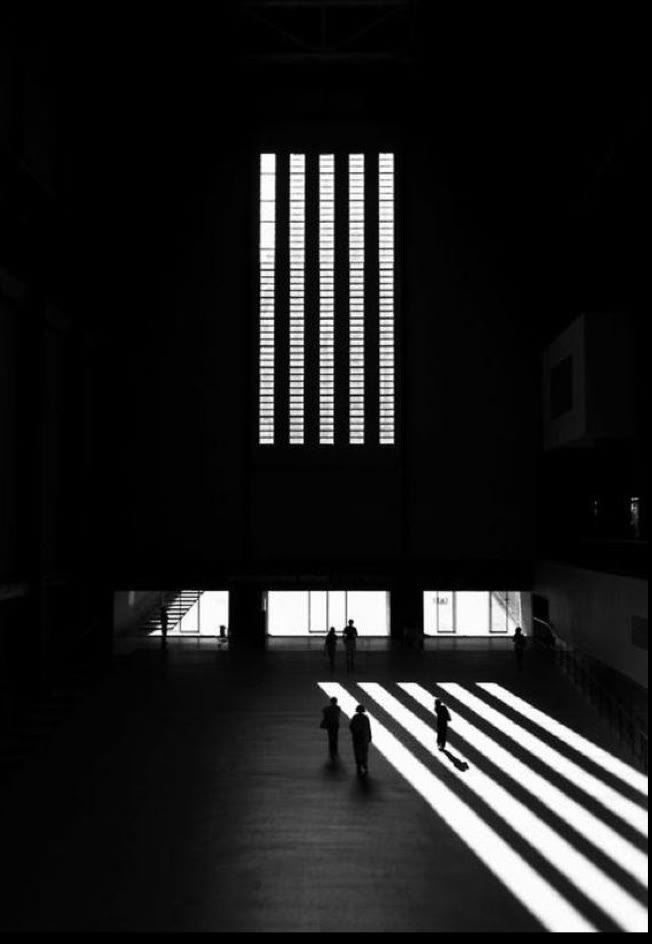 Reference: a dark hall with light falling through tall windows