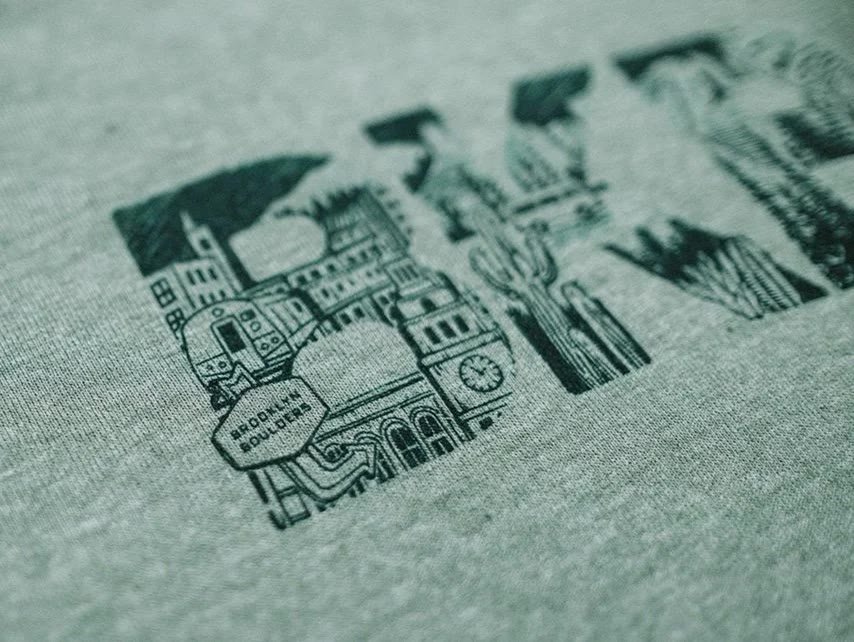 A hand-drawn city lettering printed on grey fabric
